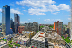 Exterior view of surrounding skyline, smaller buildings nearby, large buildings nearby, beautiful view of downtown.